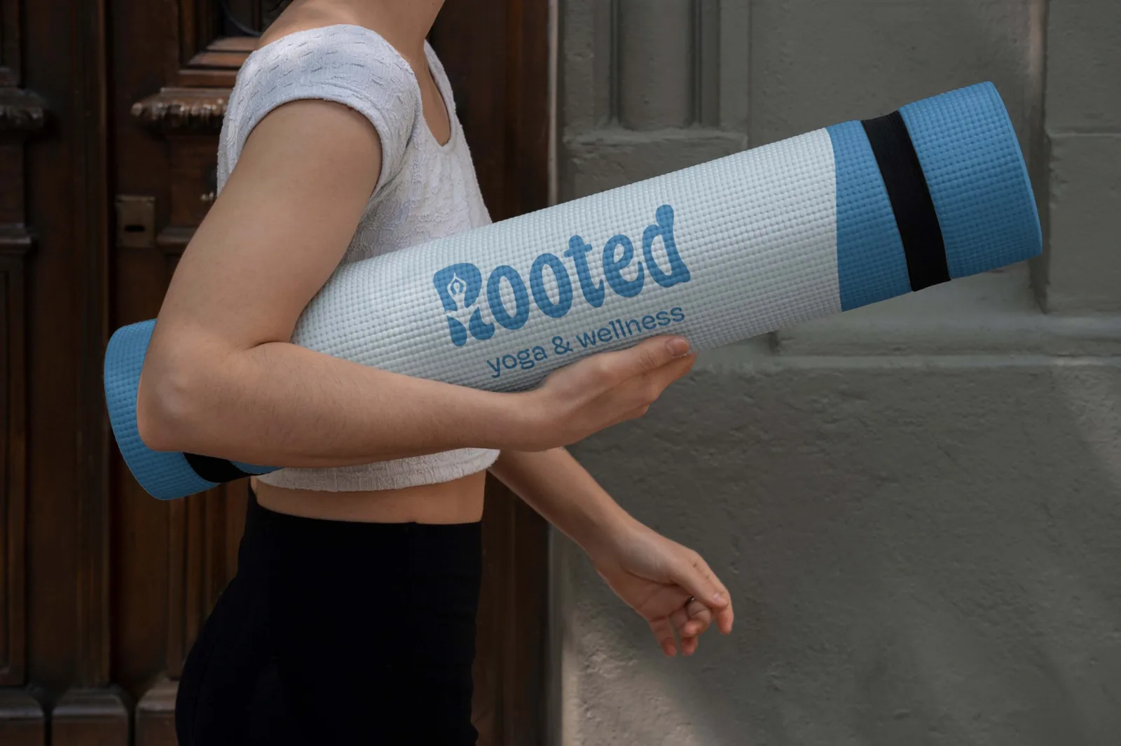 Rooted yoga mat carried under an arm